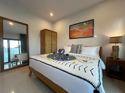 a bedroom with a large bed and a mirror at 2 bedrooms villa cinta umalas in Kerobokan