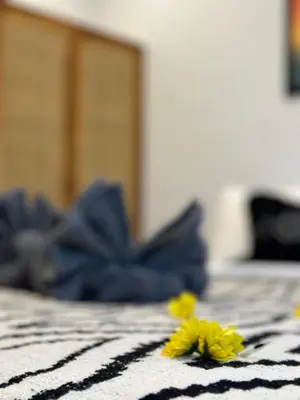 two yellow flowers on a black and white blanket at 2 bedrooms villa cinta umalas in Kerobokan