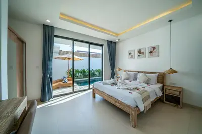 a bedroom with a bed and a large window at Villa Bagus Seminyak in Kerobokan