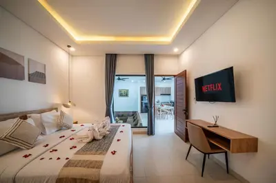 a hotel room with a bed and a desk at Villa Bagus Seminyak in Kerobokan