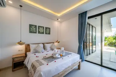 a bedroom with a bed with two teddy bears on it at Villa Bagus Seminyak in Kerobokan