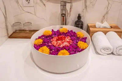 a white bucket filled with colorful flowers on a counter at Villa Bagus Seminyak in Kerobokan