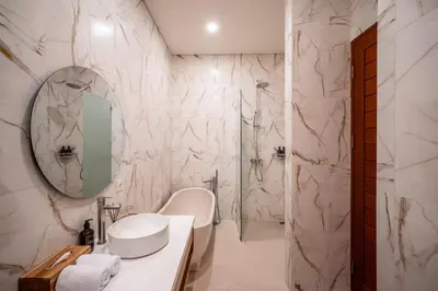 a white bathroom with a sink and a mirror at Villa Bagus Seminyak in Kerobokan