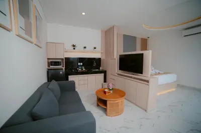 a living room with a blue couch and a table at Dikubu Bali Villa and Suites in Kerobokan