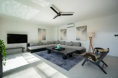 a living room with a couch and a tv at Villa Biku in Umalas