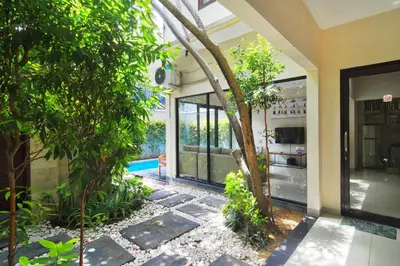 an external view of a house with a garden at Kefi Villa Seminyak in Seminyak