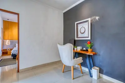 a dining room with a table and a chair at 3 Bd Pvt House with big common pool and Gym in Nusa Dua