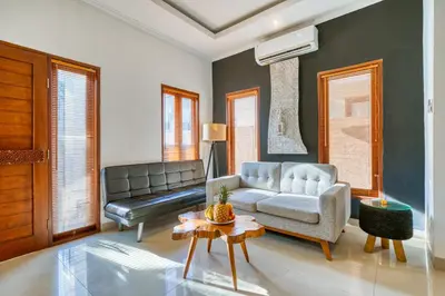 a living room with a couch and a table at 3 Bd Pvt House with big common pool and Gym in Nusa Dua