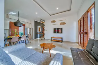 a living room with a couch and a table at 3 Bd Pvt House with big common pool and Gym in Nusa Dua