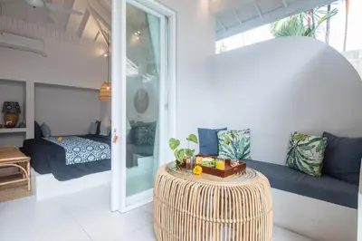 a living room with a couch and a table at The Hepburn Seminyak ADULTS ONLY Chic Boutique Room with Pool 900m Walk to Beach in Seminyak