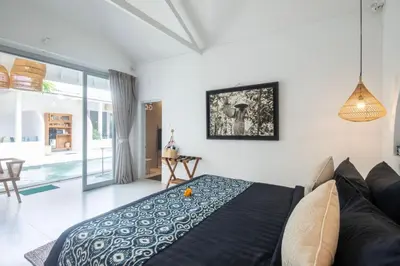 a bedroom with a bed and a couch at The Hepburn Seminyak ADULTS ONLY Chic Boutique Room with Pool 900m Walk to Beach in Seminyak