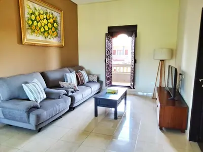 a living room with a couch and a table at Shira House Bali in Legian