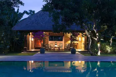 a house with a pool in front of it at Villa MAMOUNE in Canggu