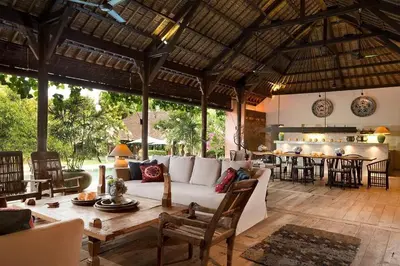 a living room with a couch and a table at Villa MAMOUNE in Canggu