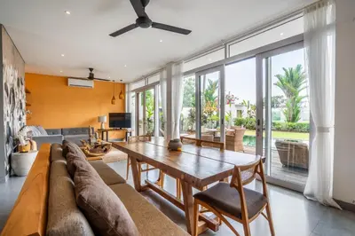 a living room with a couch and a table at Athos Villa by iBali Management in Seminyak
