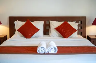 a bed with two pairs of shoes sitting on it at Kusuma Coliving & Villas in Canggu