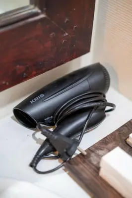 a black phone sitting on top of a desk at Kusuma Coliving & Villas in Canggu