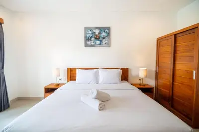 a bedroom with a bed with two towels on it at Kusuma Coliving & Villas in Canggu