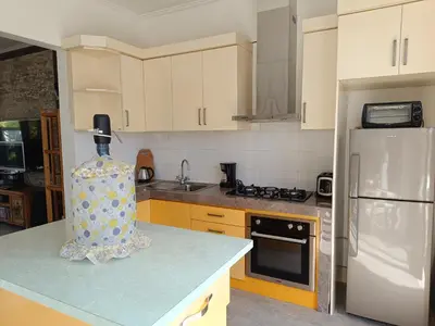 a kitchen with a white refrigerator and a counter top at Casa Dijaweqo in Jimbaran