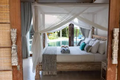 a bedroom with a canopy bed and a pool at Villa Malya 5 bedrooms Seminyak in Seminyak