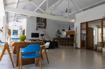 a living room with a table and blue chairs at Villa Malya 5 bedrooms Seminyak in Seminyak