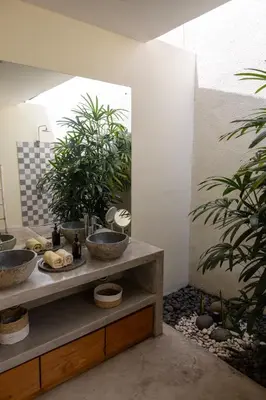 a bathroom with two sinks and two potted plants at Villa Malya 5 bedrooms Seminyak in Seminyak