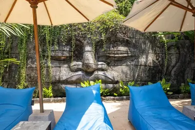 a mural of a head with pillows and umbrellas at Villa Malya 5 bedrooms Seminyak in Seminyak