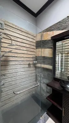 a bathroom with a glass shower with a sink at MOOvilla 1 Seminyak, Bali in Umalas