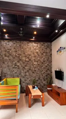 a living room with a couch and a table and a tv at MOOvilla 1 Seminyak, Bali in Umalas