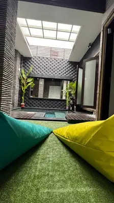 a room with two play tents on the grass at MOOvilla 1 Seminyak, Bali in Umalas