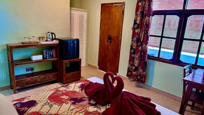 a bedroom with a bed with a red robe on it at Ellenbrook Rooms 18 by Mulia Cottage in Seminyak