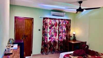 a bedroom with a curtain and a bed and a ceiling at Ellenbrook Rooms 18 by Mulia Cottage in Seminyak