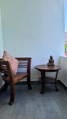 a bench and a table with a pillow and a stuffed animal at Ellenbrook Rooms 18 by Mulia Cottage in Seminyak