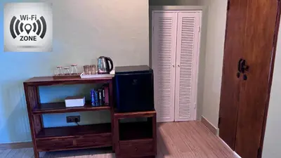 a room with a wooden book shelf and a door at Ellenbrook Rooms 18 by Mulia Cottage in Seminyak