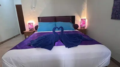 a bedroom with a bed with a blue ribbon on it at Ellenbrook Rooms 17 by Mulia Cottage in Seminyak