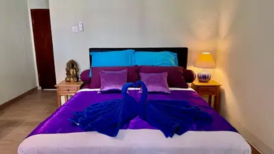 a purple bed with a blue bow on it at Ellenbrook Rooms 17 by Mulia Cottage in Seminyak