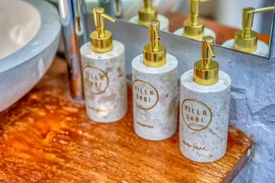 a group of four bottles sitting on a counter at Villa Sabi 3BR in the Heart of Seminyak by Santi Management in Seminyak