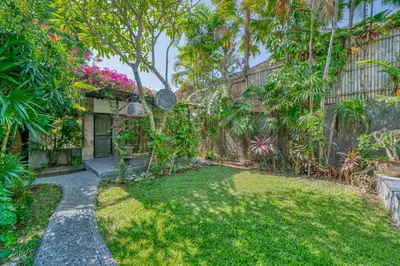 a house with a garden with trees and plants at Villa Sabi 3BR in the Heart of Seminyak by Santi Management in Seminyak