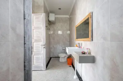 a bathroom with a sink and a toilet at Villa Chunga-changa Double six in Seminyak