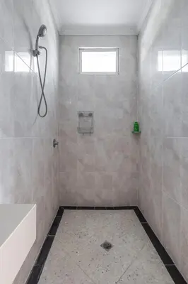 a bathroom with a shower and a tub and a sink at Villa Chunga-changa Double six in Seminyak
