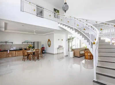 a white staircase in a living room with a dining room at Villa Chunga-changa Double six in Seminyak