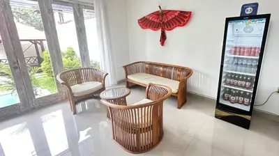 a room with chairs and a vending machine with drinks at Villa Chunga-changa Double six in Seminyak