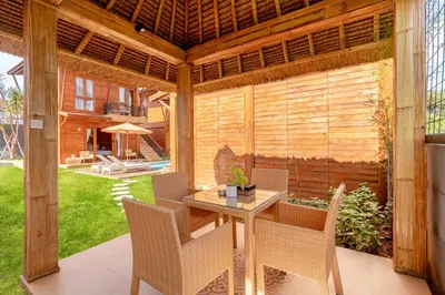 an outdoor patio with a table and chairs at Anartha Resort Jimbaran By Kubu GWK in Jimbaran