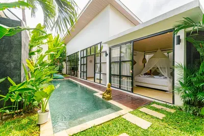 a villa with a swimming pool and a bedroom at Mya Harmony Villas Seminyak in Seminyak
