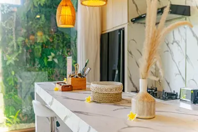 a kitchen counter with a table with some items on it at Mya Harmony Villas Seminyak in Seminyak