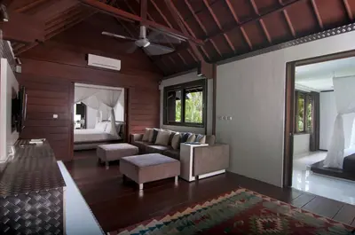 a living room with a couch and a bed at 5BR Villa Sabtu - Minggu Villas Seminyak in Seminyak