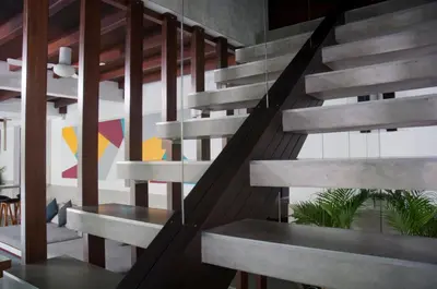 a staircase in a building with wooden railings at 5BR Villa Sabtu - Minggu Villas Seminyak in Seminyak