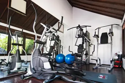 a gym with several exercise bikes in a room at 5BR Villa Sabtu - Minggu Villas Seminyak in Seminyak