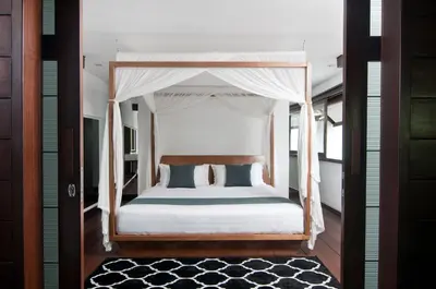 a bedroom with a bed with a canopy at 5BR Villa Sabtu - Minggu Villas Seminyak in Seminyak
