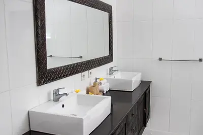a bathroom with two sinks and a mirror at Villa Gardenia - 6 Bedrooms with Pool in Seminyak in Seminyak